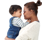 Happy woman holding on her back a baby with her arms raised